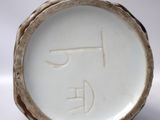 a close up of a white plate with a face on it