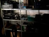 a shelf with many electronics on it in a dark room