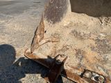a rusted piece of machinery sitting on the ground