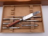 a knife in a box with six knives in it