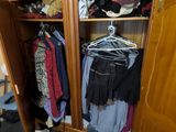 une photo d'une armoire remplie de vêtements dans une pièce