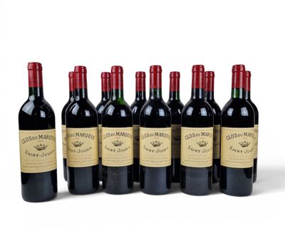 six bottles of red wine lined up in a row on a white surface