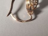 a silver spoon with a flower on it sitting on a table