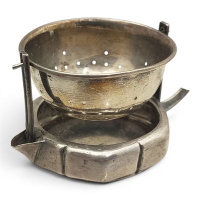a metal bowl that is sitting on top of a saucer