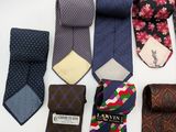 many ties laid out on a white surface