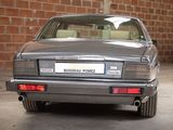 a silver car parked in a garage with a brick wall in the background