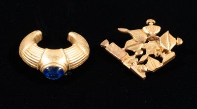 two pieces of gold and blue stone earrings on a black surface