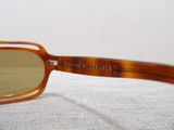 brown glasses with brown lenses sitting on a white surface