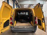 a yellow van with its doors open in a building