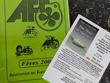 a green book with a picture of a bicycle on it next to a brochure