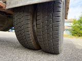 a close up of a truck tire on the road