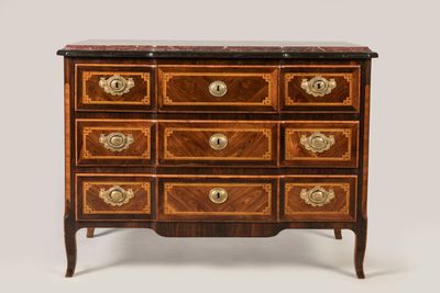 an antique chest of drawers with a marble top