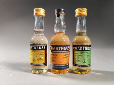 three bottles of liquor sitting on top of a table next to each other
