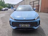 a blue car parked in front of a building