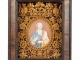 a framed picture of an old man with a beard and a blue robe