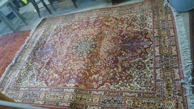un grand tapis oriental sur le sol d'une pièce