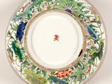 a close up of a plate with flowers and birds on it