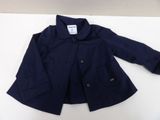 a close up of a blue jacket on a white surface