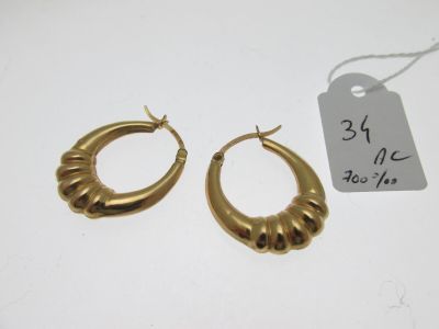 two pairs of gold hoop earrings with a price tag on a white background