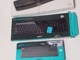 three different keyboards and a mouse on the table