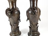 two vases that are sitting on a white surface