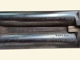 an old gun with a wooden barrel and a metal handle