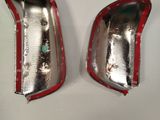 two pieces of silver and red paint on the side of a car