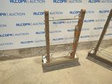 two metal racks that have been placed in front of a wall