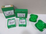 four green boxes of electronic components sitting on a white surface