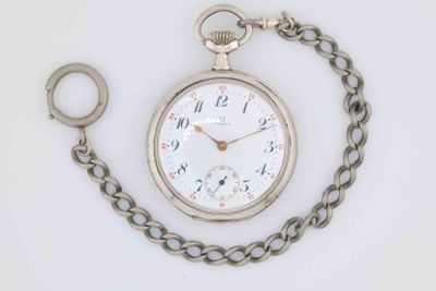 a silver pocket watch with a chain around it