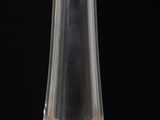 a glass on a wooden table with a black background
