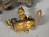 brass figurine of a man on a boat with a bird on it
