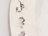 a white plate with writing on it on a table
