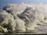 a picture of a large wave crashing on the beach
