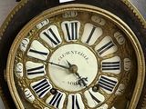 a clock with roman numerals on the face of it