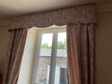 a window that has a curtain on the side of it