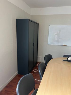 an image of a conference room with a whiteboard on the wall