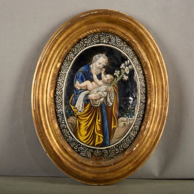 a picture of a gold frame with a picture of a woman holding a baby
