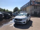 a white car that is parked in front of a building