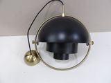 an image of a black and gold lamp hanging on a wall