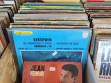 a lot of vinyl records in a box on the table