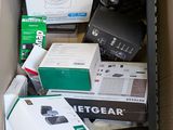 a cardboard box full of electronic equipment on the floor