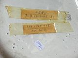 a white plate with two tags on it sitting on a table