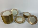 six pieces of gold and white porcelain plates with gold rims