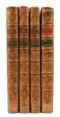 a set of four old books sitting on top of each other