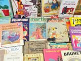 many children ' s books that are on a table