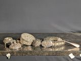 a silver tray with silver objects on it on a table