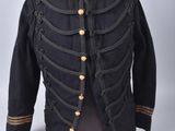 une veste militaire noire avec des boutons dorés et un col rouge