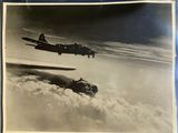 an old photo of two planes flying in the sky