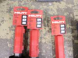 two red tools that are sitting on the floor
